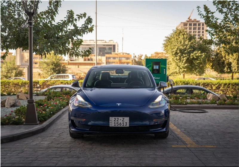 Tesla electric vehicle connected to a charging station